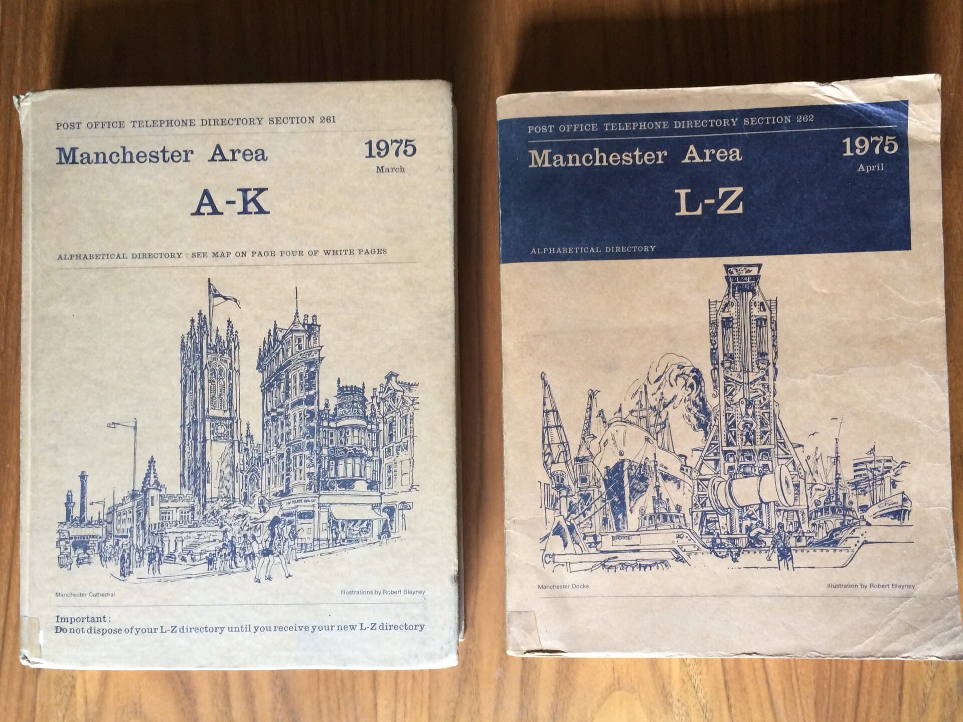 Two 1975 Manchester telephone directories lying on a wooden table